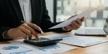 Person analyzing financial documents and investment charts on a tablet for retirement planning